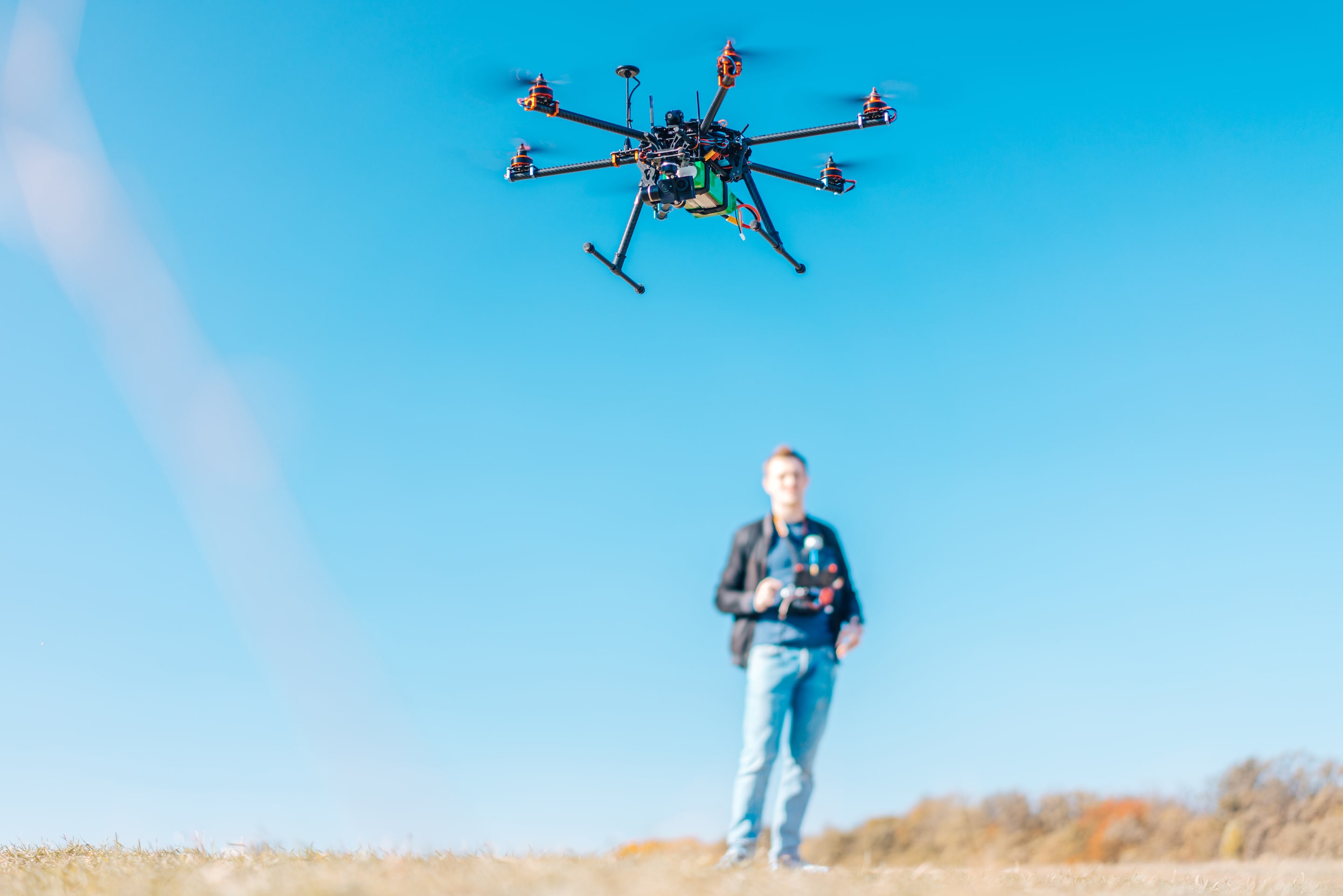 Young man navigating drone