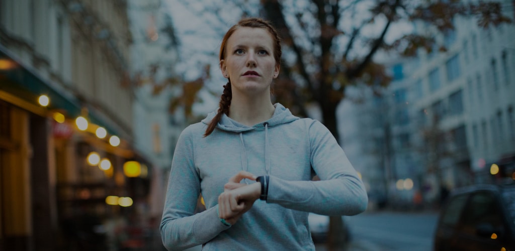  Sporty woman checking smartwatch