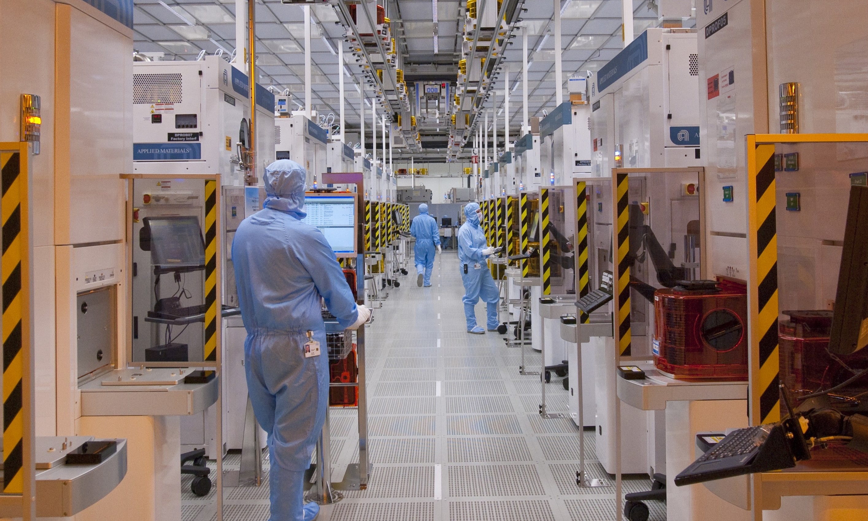 Semiconductor fabrication line inside industrial cleanroom.