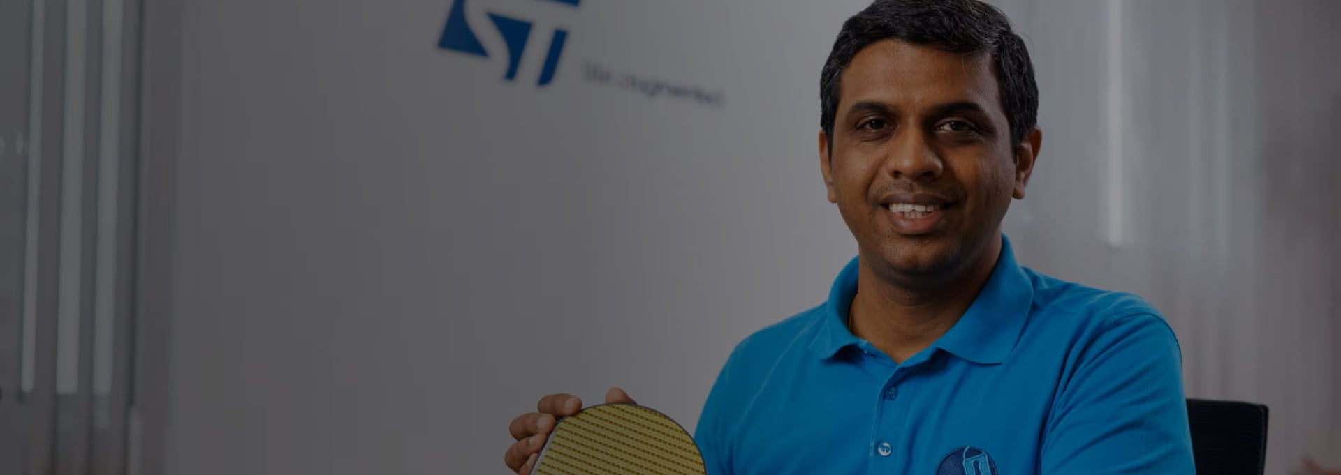 Man holding a wafer from ST Microelectronics 