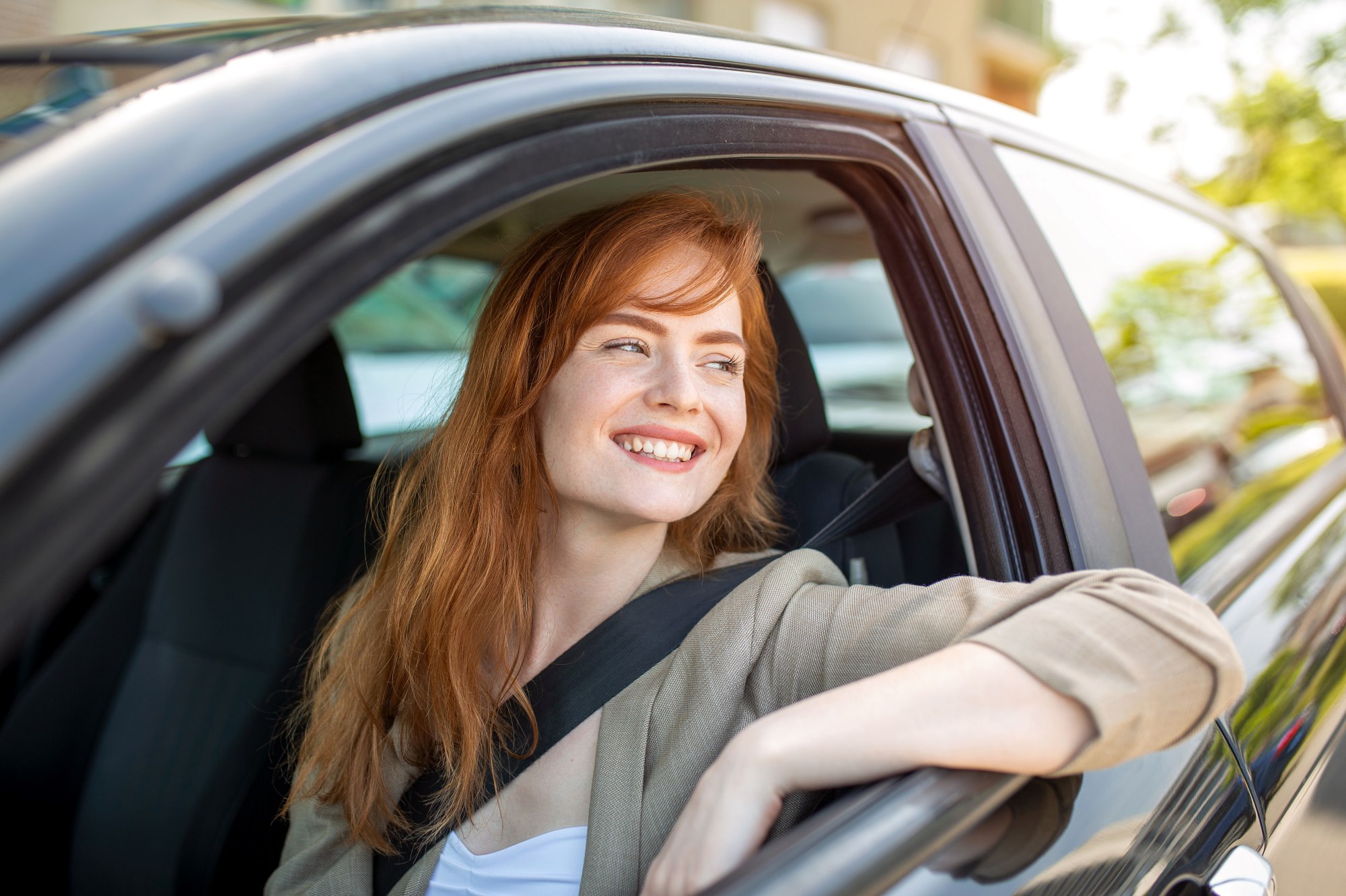 Close up portrait of woman in casual wear driving a car
