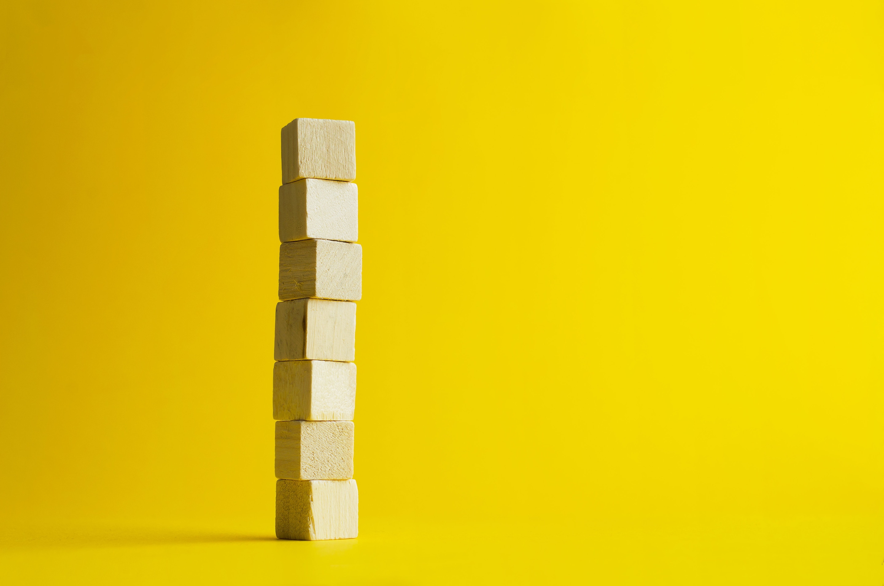 Plain wooden cubes piled on top of each