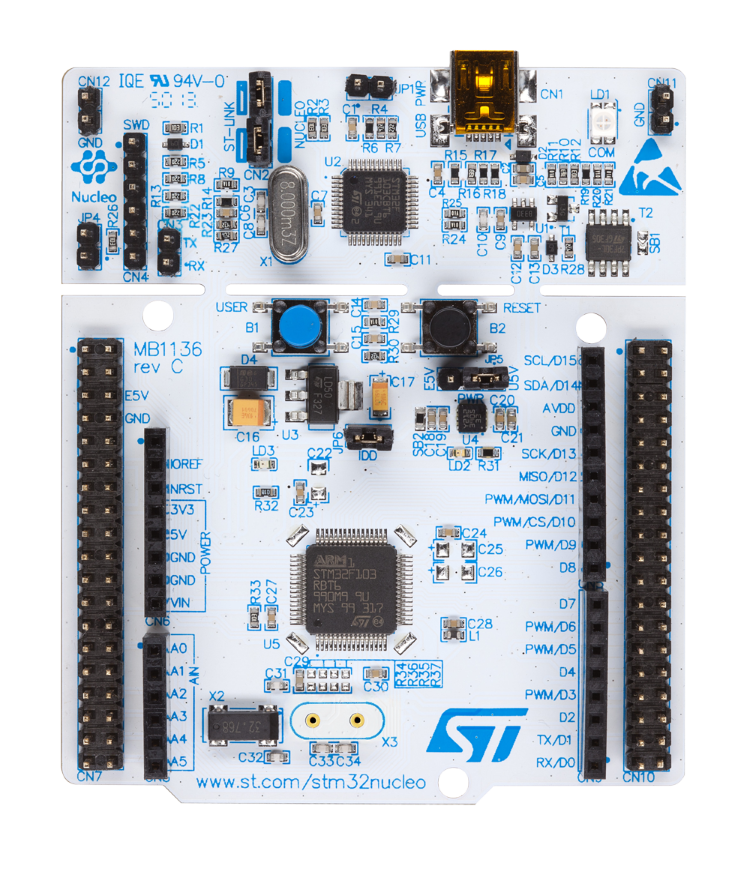 Blue and white electronic development board with a central microcontroller and multiple input/output pins.