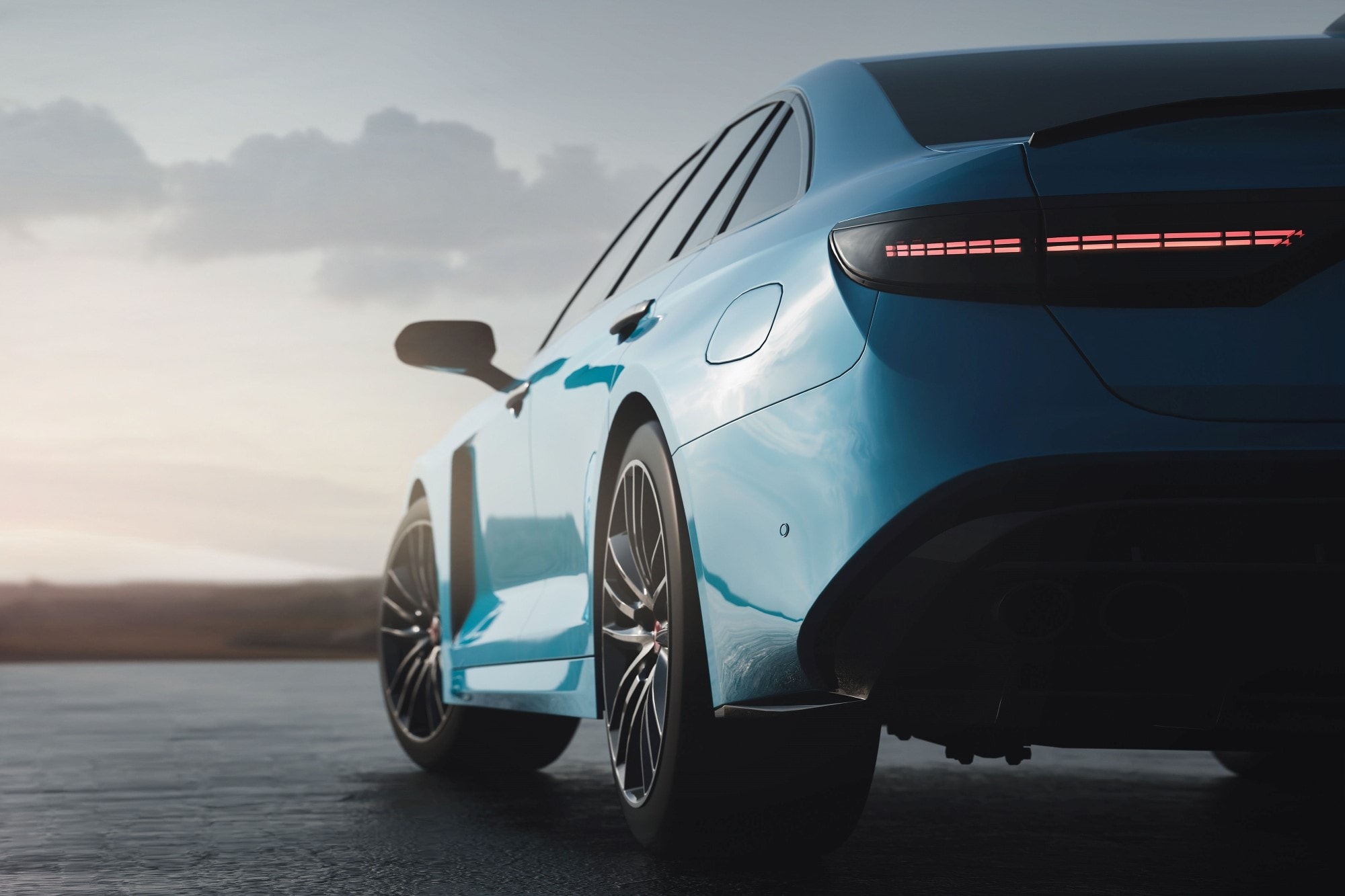 A sleek blue sports car parked on an open road at sunset.