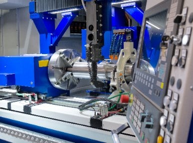 Industrial cnc lathe system with HMI control unit in foreground