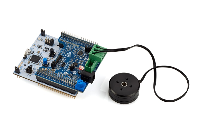 STMicroelectronics development board connected by cable to a small round motor module. 